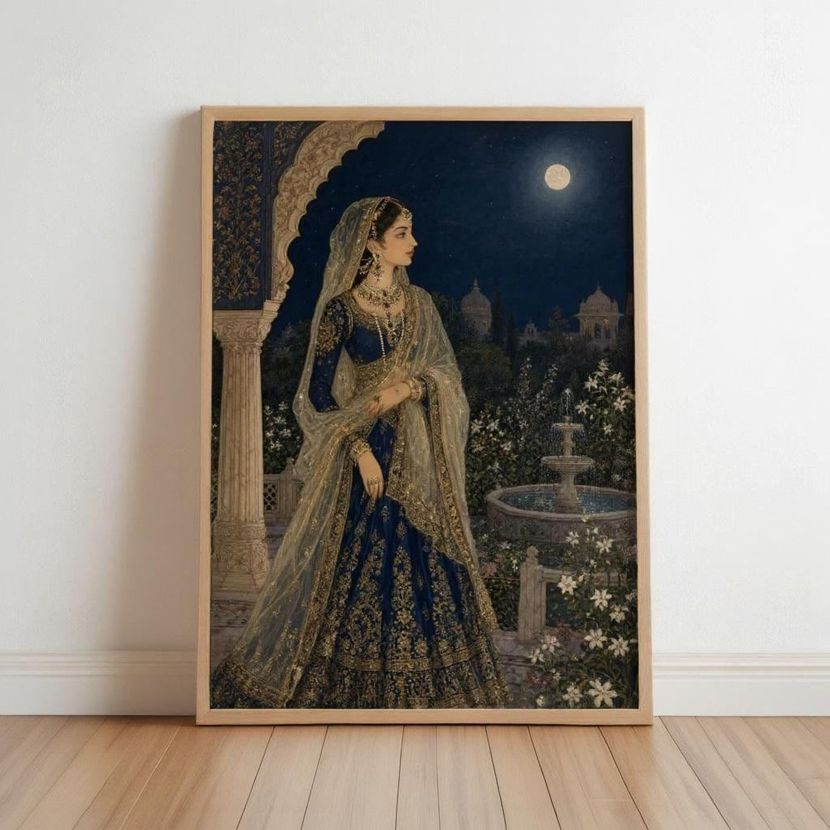 The image is a framed painting depicting a woman in traditional Indian attire, standing in a garden at night with a full moon in the sky.