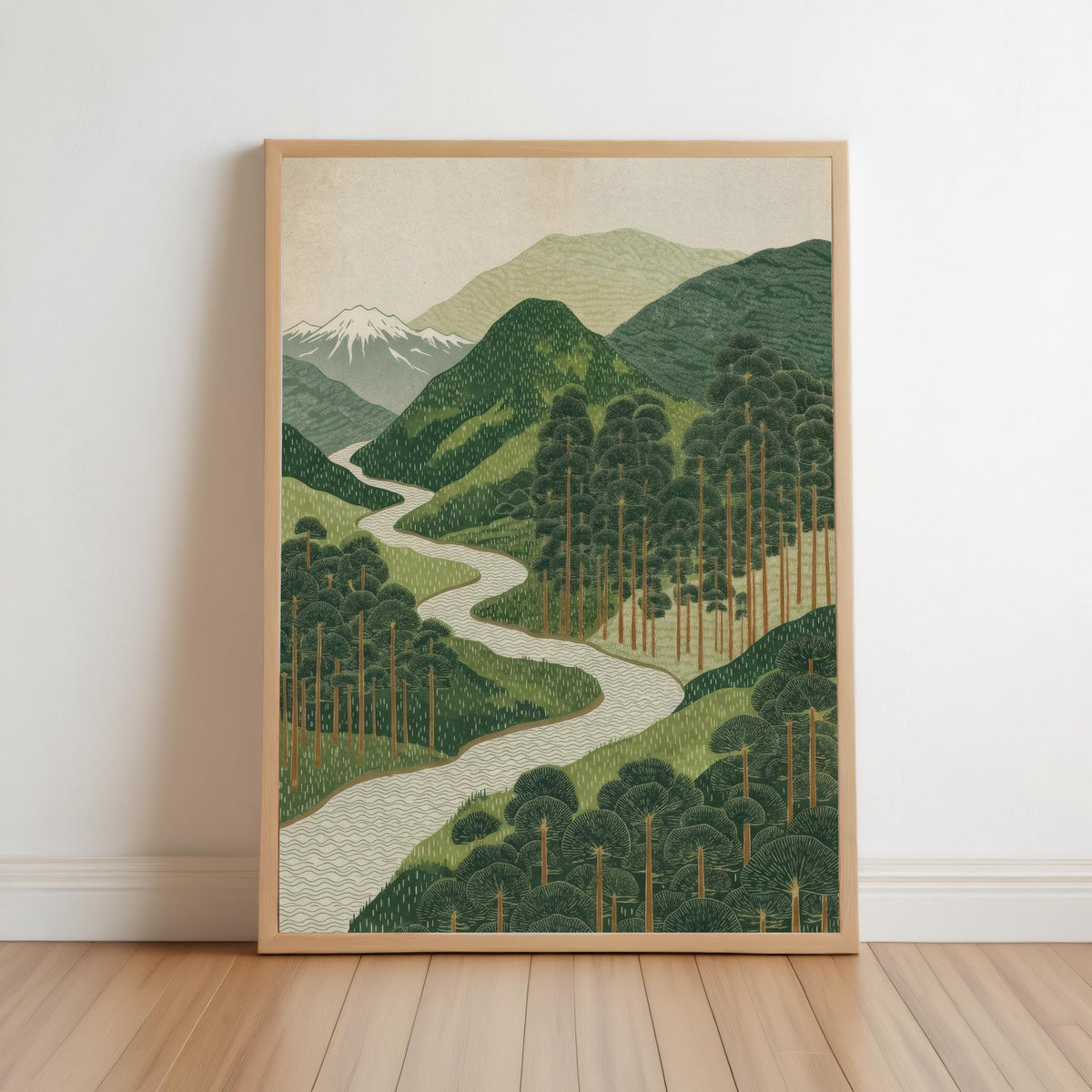 Light wood framed Japanese mountain landscape wall art leaning on floor, muted greens and winding river