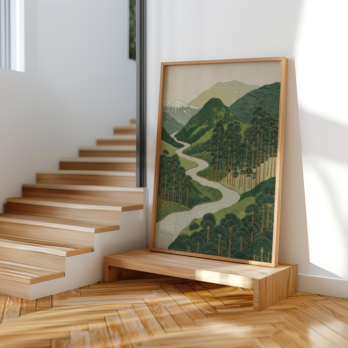 Framed Japanese mountain landscape wall art propped on wooden stairs, Japandi nature wall decor in warm light