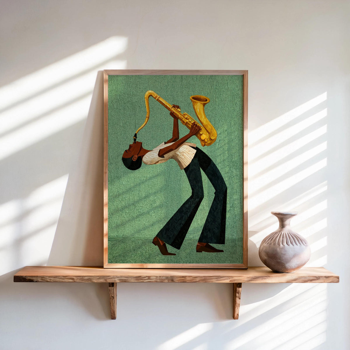 Framed afrocentric jazz wall art print leaning on shelf, green textured canvas, golden sax.