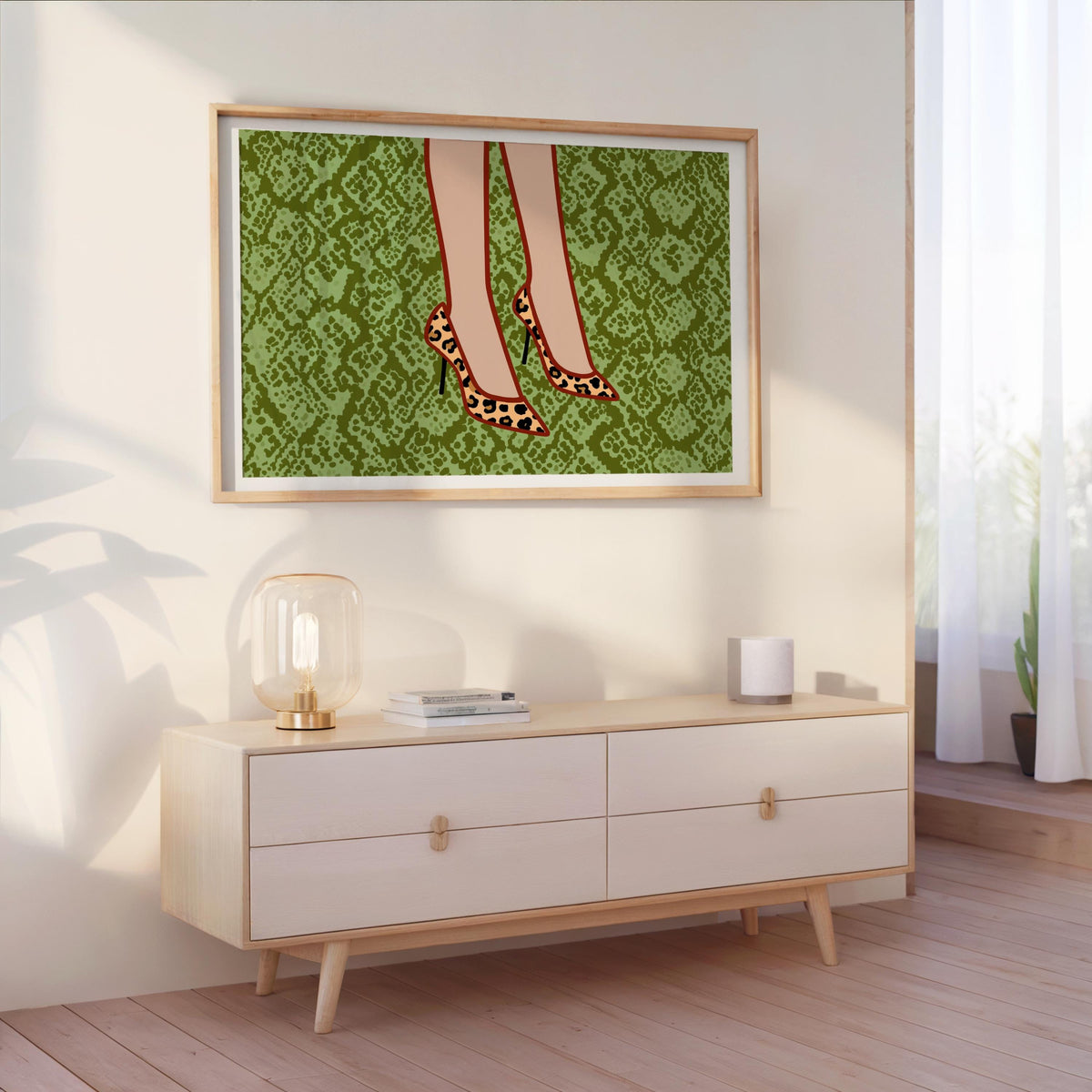 Leopard print heels wall art hung above dresser in bright bedroom, green snake-print background, boutique wall decor vibe