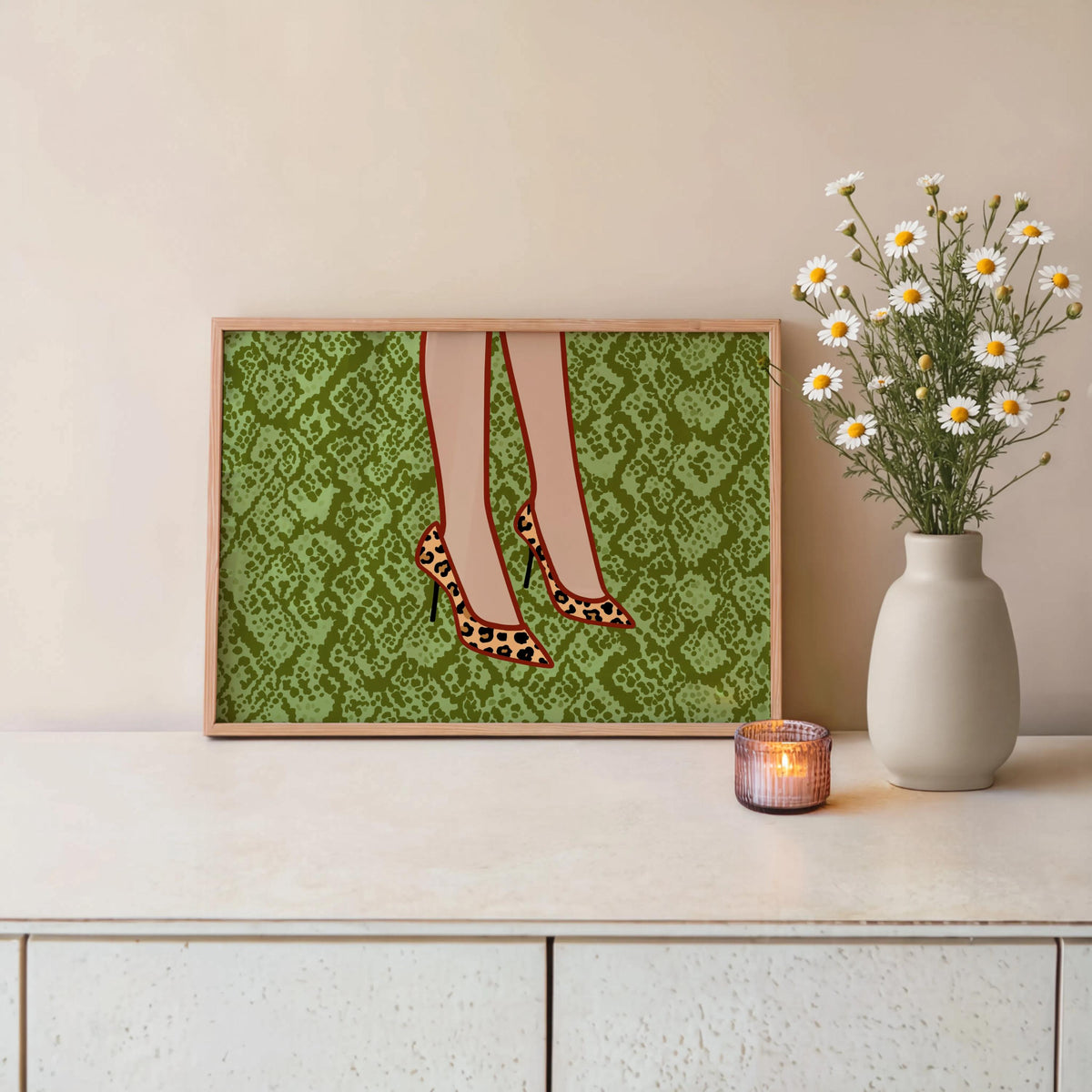 Leopard print heels wall art on console table with vase and candle, textured green snake-print adds maximalist flair