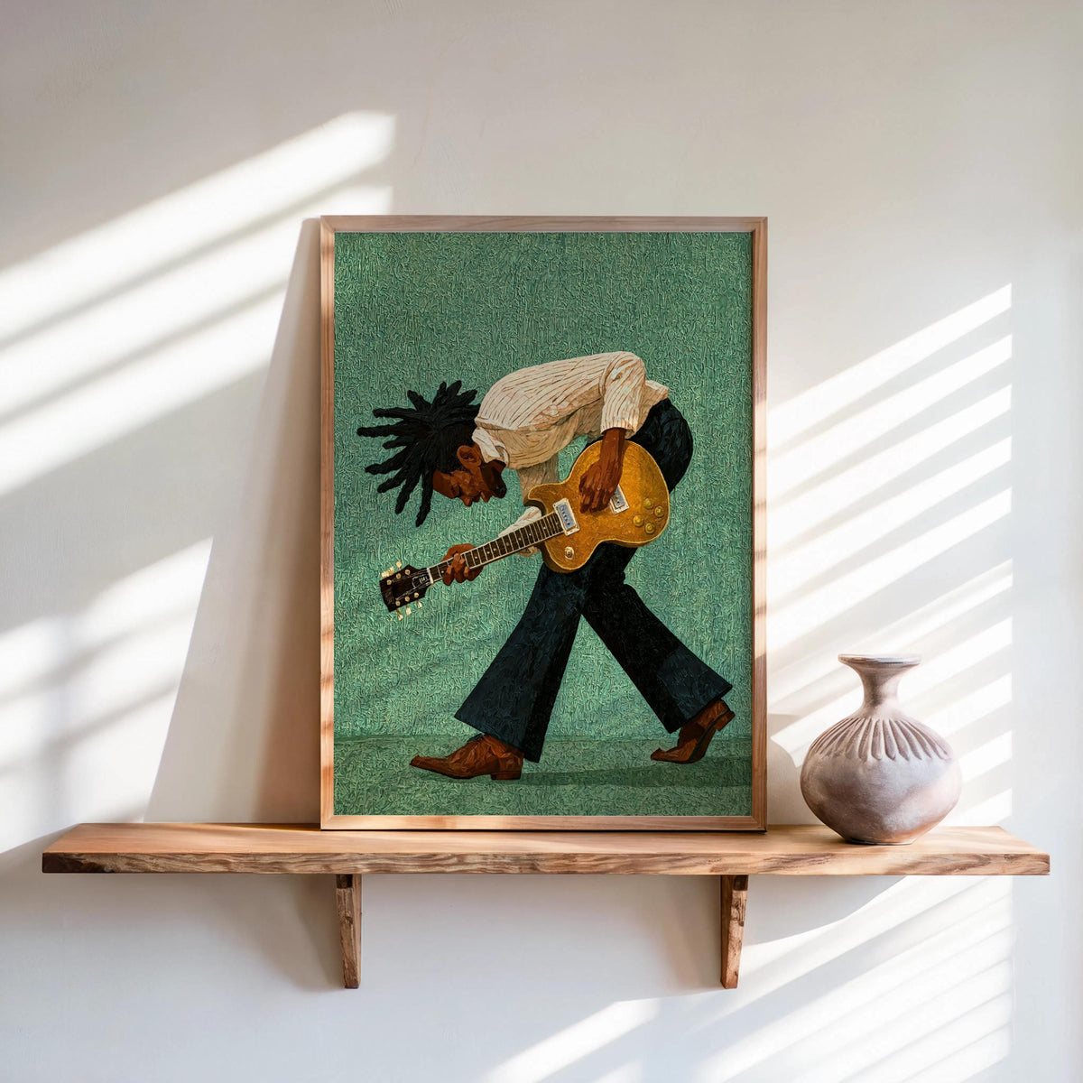 Framed print on shelf, green background, stylized guitarist leaning in, Black musician wall art