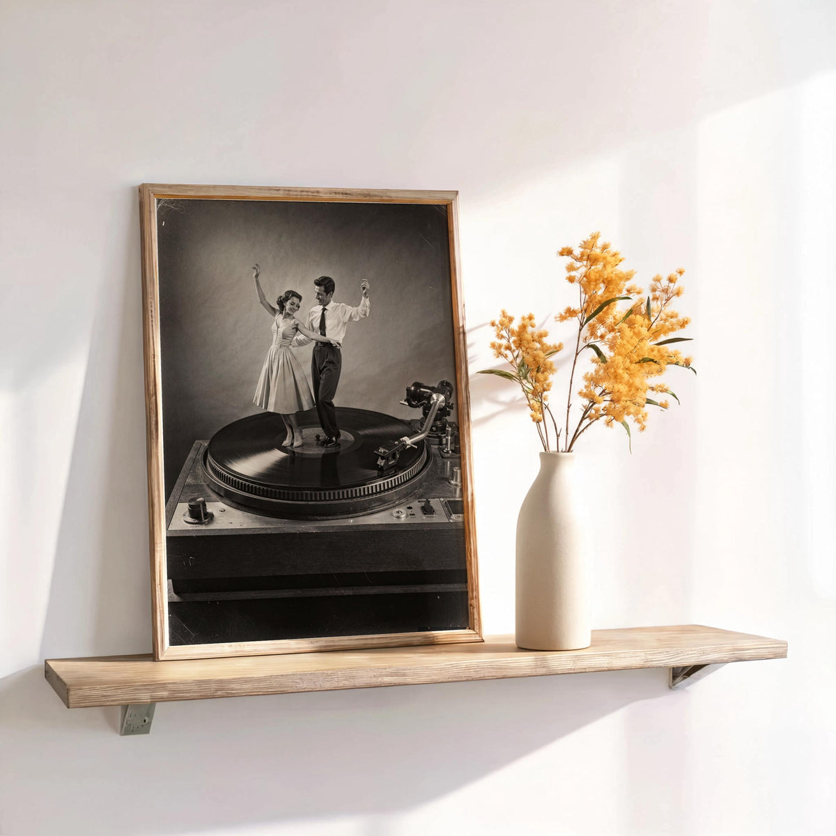 Leaning black-and-white record player wall art on a floating shelf, dried flowers add vintage living room charm
