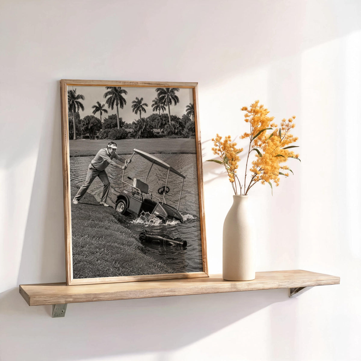 Angry golfer poster leaning on shelf beside a vase with yellow flowers, vintage black and white.