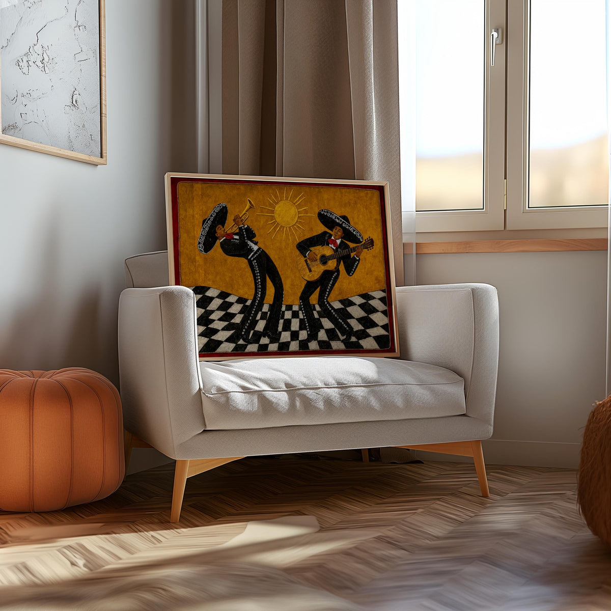 Small framed mariachi art print on an upholstered chair by a window, Mexican home decor vignette