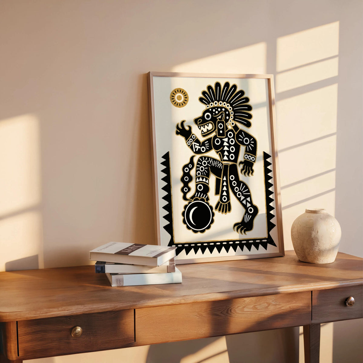 Tezcatlipoca art print propped on a wooden desk, sunlit corner with pottery and books, Mexican wall decor styling