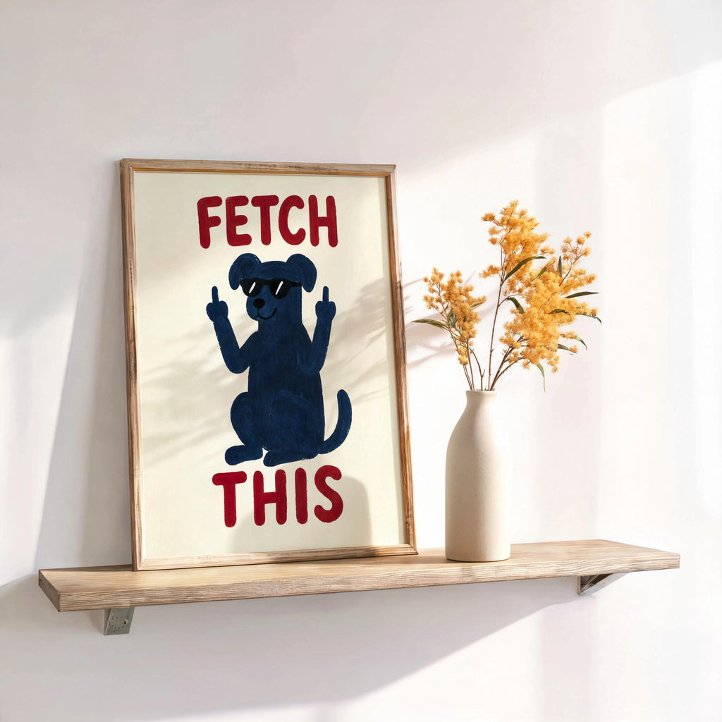 Shelf vignette with navy dog FETCH THIS print, dried stems in a vase, warm light, humorous animal print for dog lovers