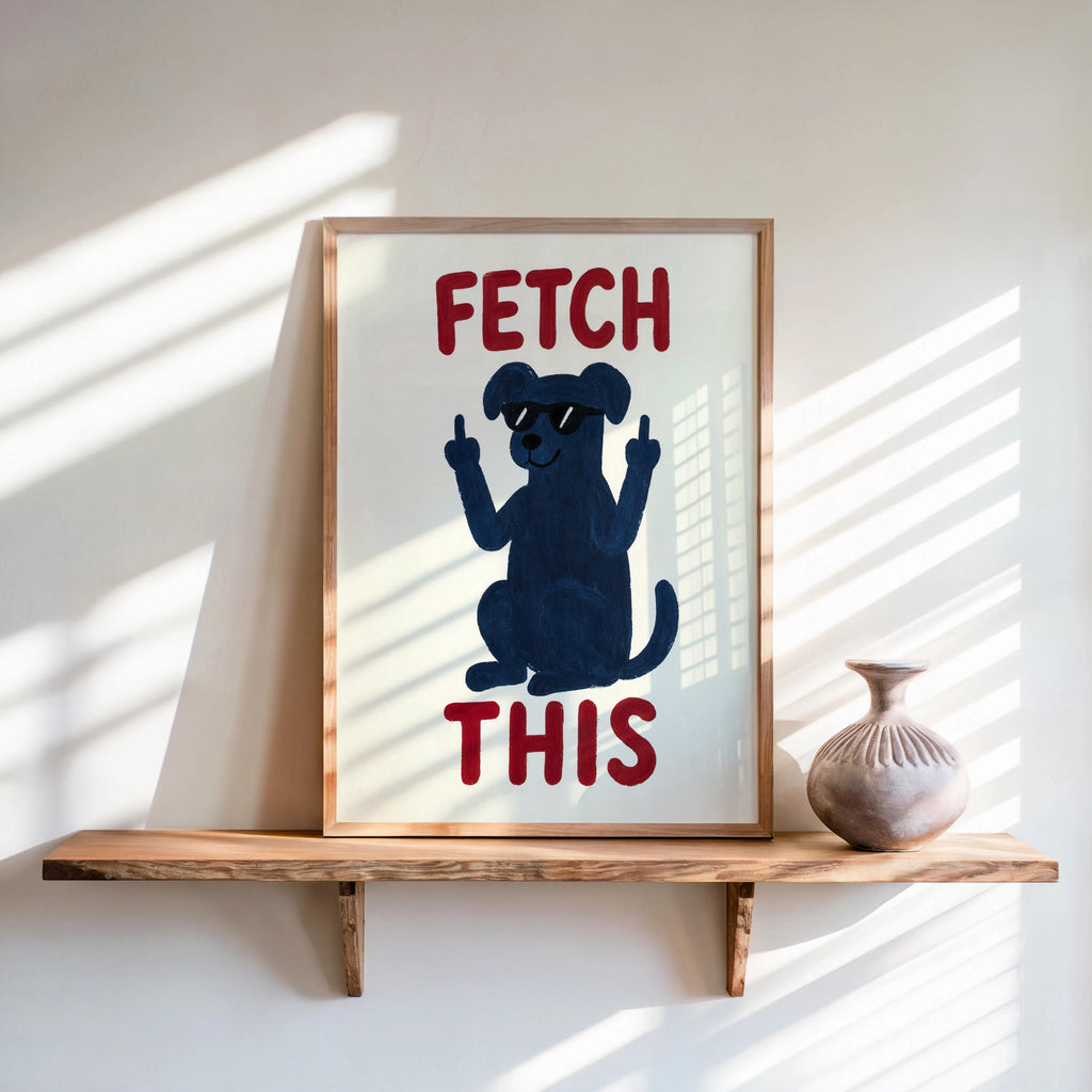 Framed navy dog poster on wall shelf, rust red lettering reads FETCH THIS, retro color palette, funny dog print for sill