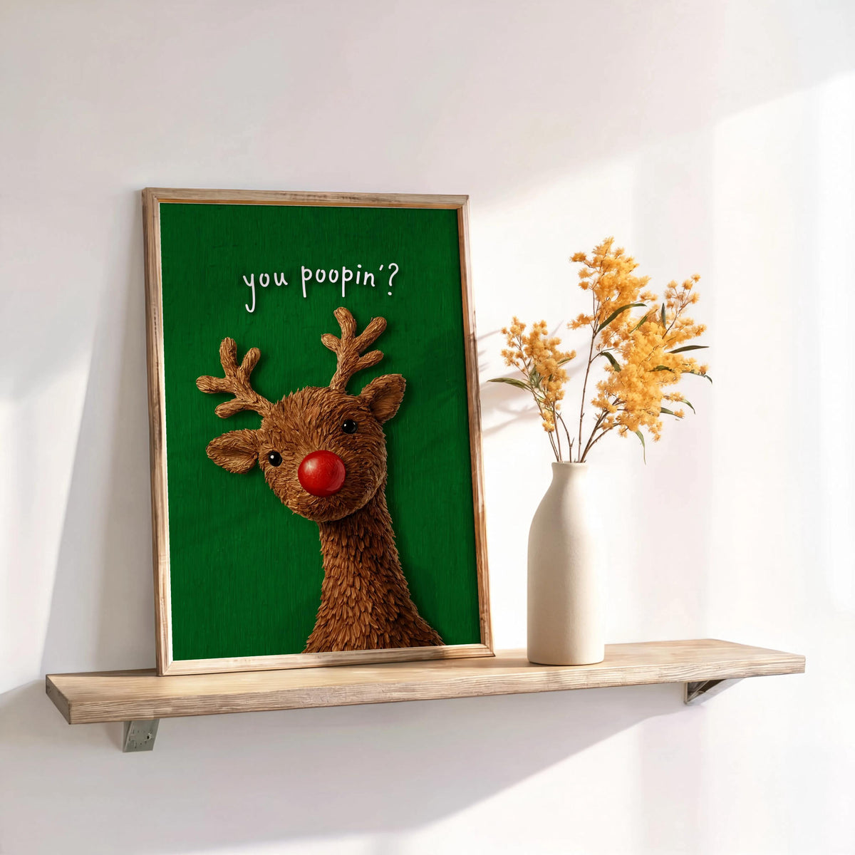 Forest green framed Rudolph with dried stems, festive restroom art styling, playful Christmas bathroom wall decor idea
