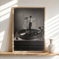 Framed black-and-white record player wall art, dancing couple on vinyl, sunlit shelf vignette