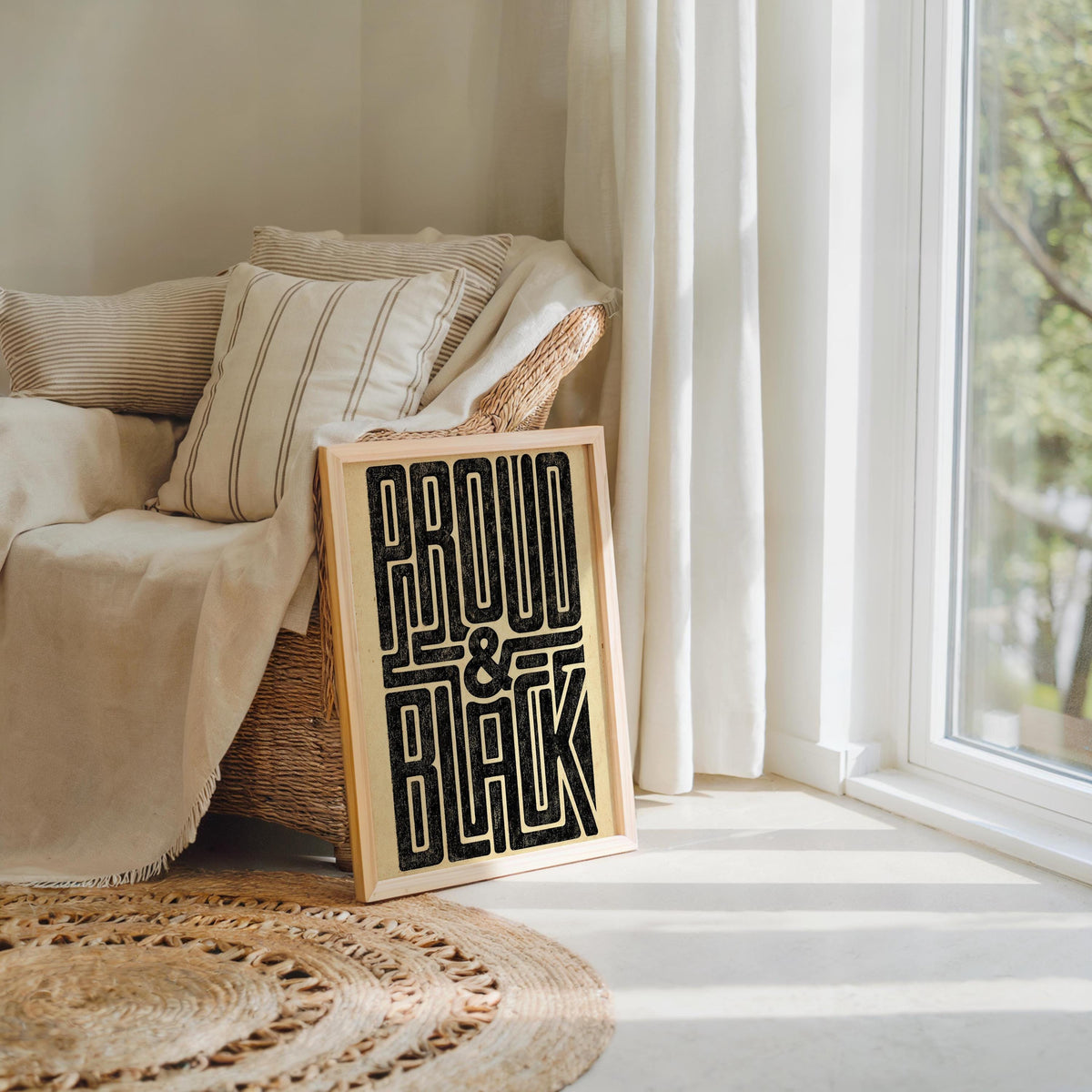 Cozy living corner with textured rug and sofa, Proud and Black poster leaning on floor, Afrocentric wall art feel