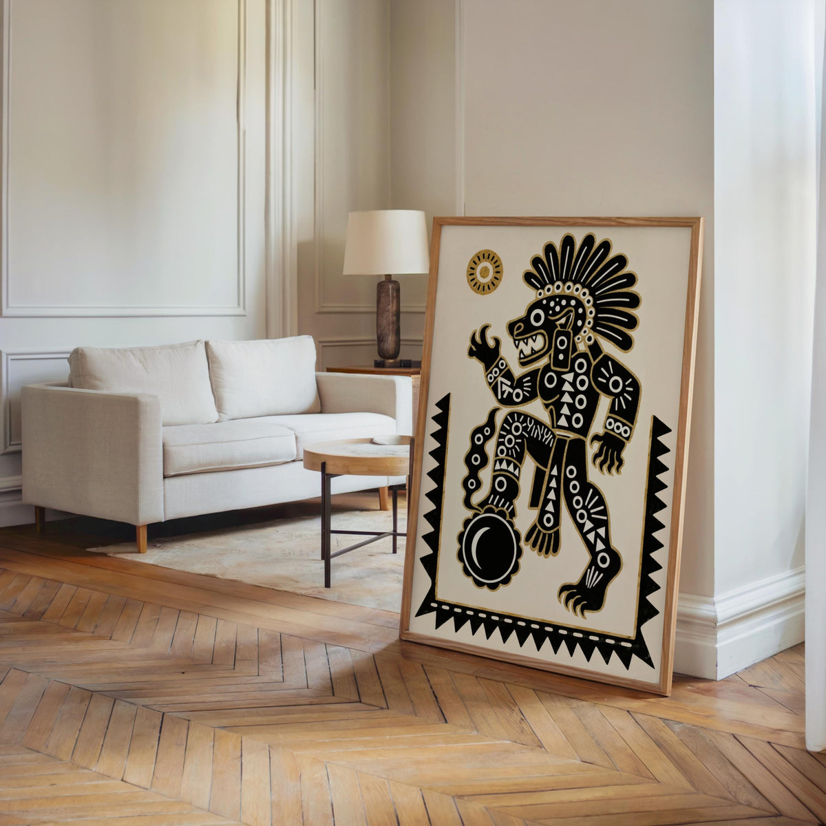 Tezcatlipoca art print leaning beside sofa in a warm living room, bold black and gold wall art statement