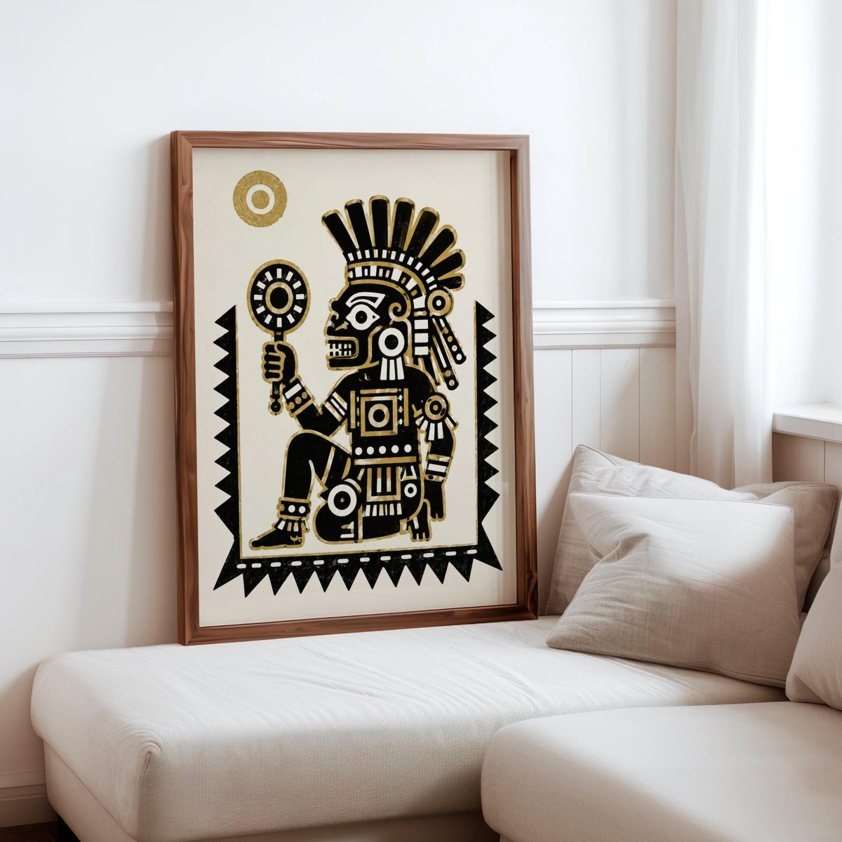 Framed Tezcatlipoca art print on a cozy sofa corner, black and gold wall art adding tribal inspired contrast