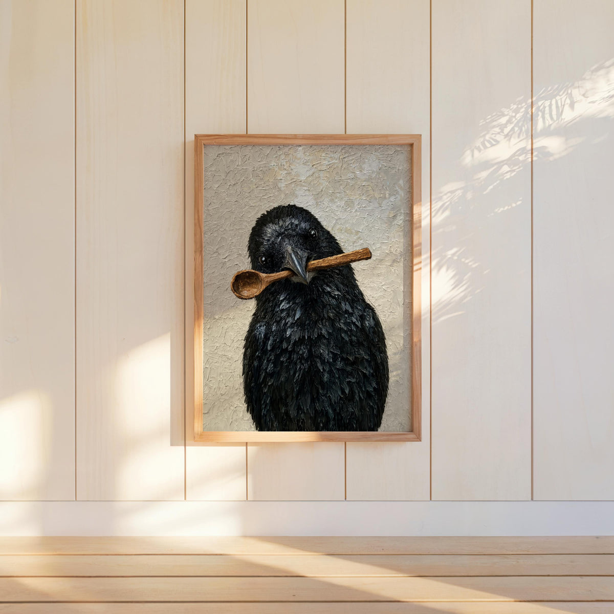 Small framed funny crow wall art hung on cream shiplap, soft sunlight, creepy cute expression