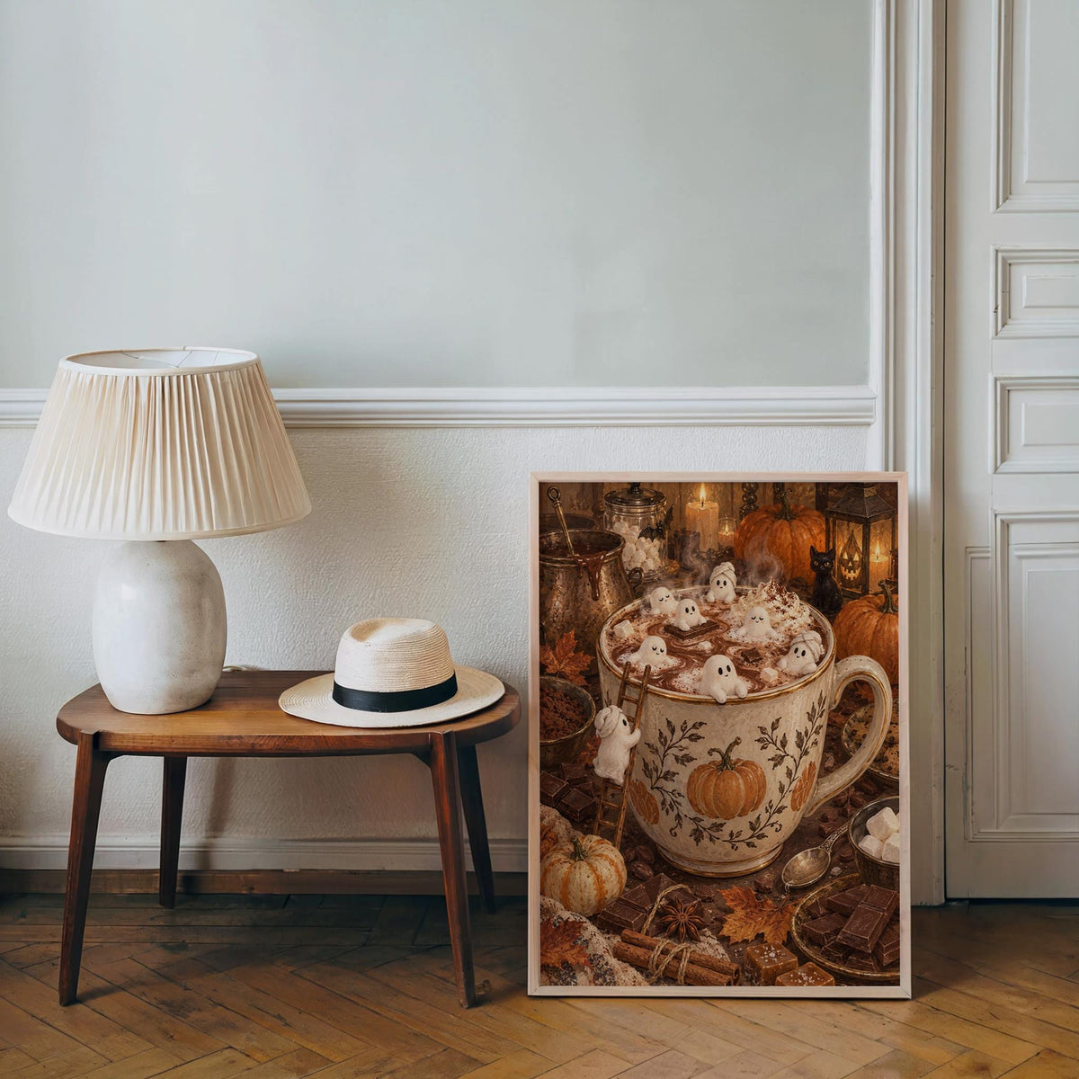 Cozy Halloween poster leaning by a side table and lamp, neutral decor, whimsical ghost print feel