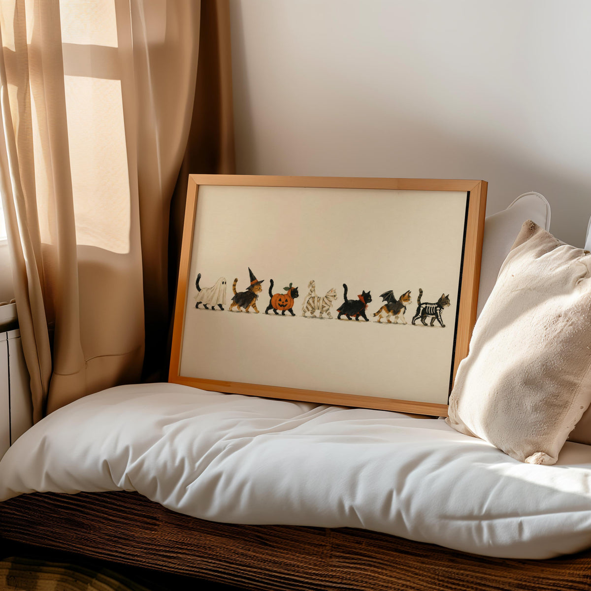 Halloween cat wall art propped on cozy bed, costume cat illustration, vintage storybook charm.