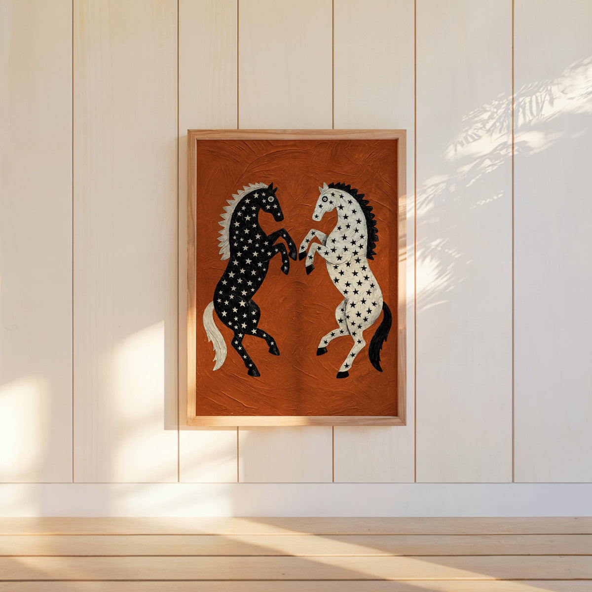 Hanging rearing horse wall decor on pale vertical planks, sunlit room, textured rust orange western art with contrasting star-patterned horses