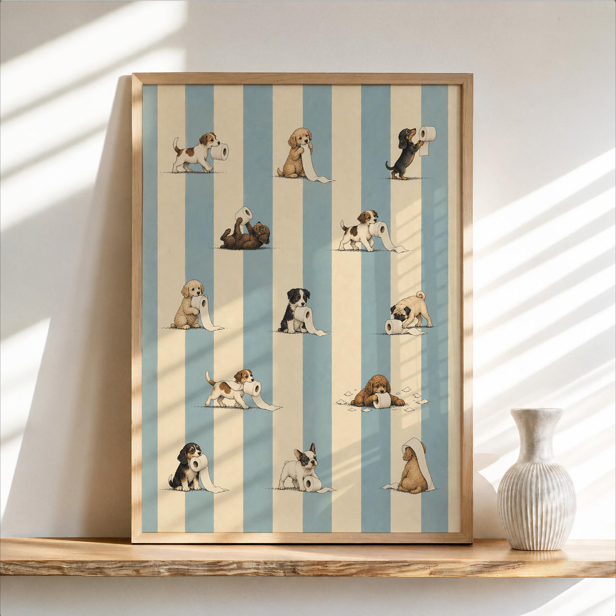 Framed blue-and-cream striped print on shelf, vintage puppies tangling toilet paper, funny dog bathroom wall art