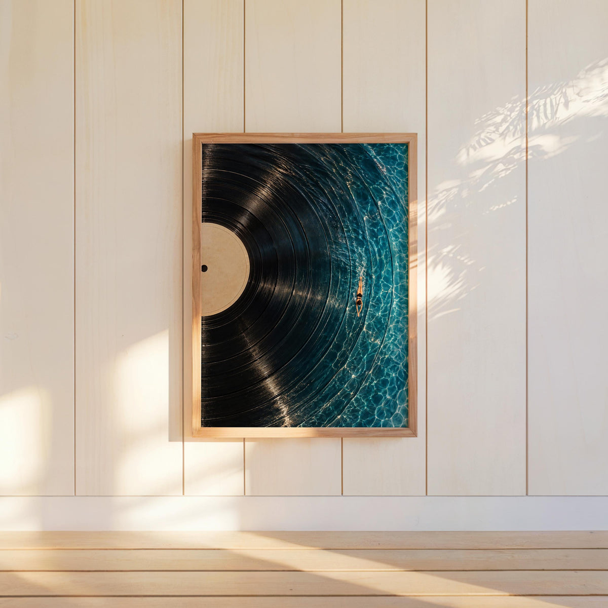 Vertical vinyl record wall art hung on white paneled wall, warm sunlight emphasizes the turquoise grooves