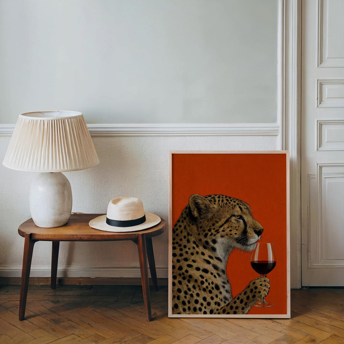 Cheetah wine wall art resting by a side table and lamp in a cozy corner, eclectic gallery wall vibe.