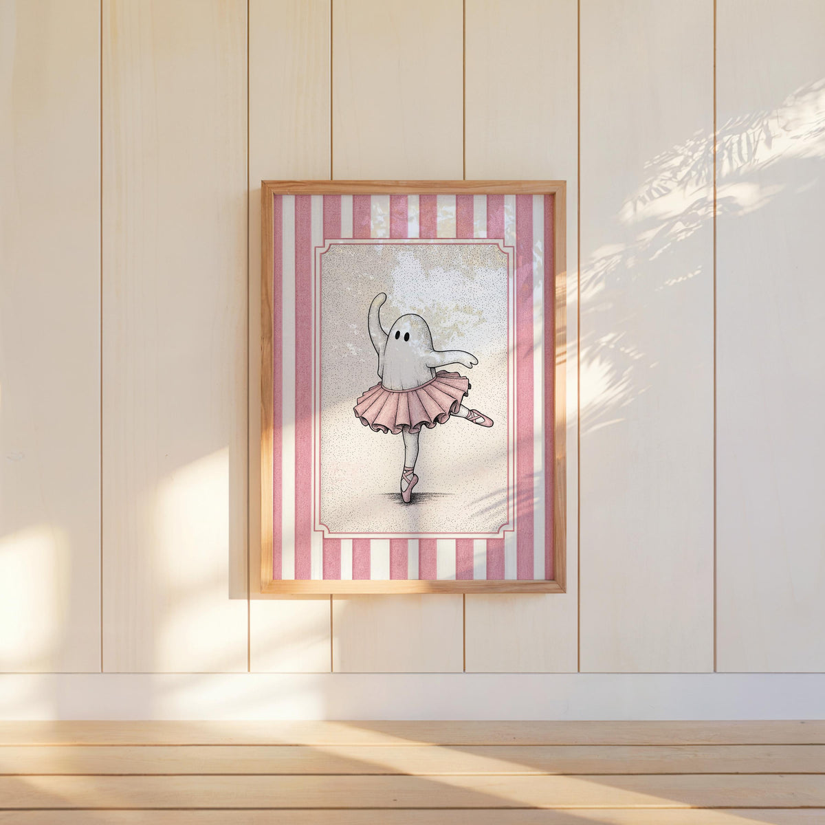 Framed ballerina ghost poster hung on pale shiplap wall, sunlit nursery mood, ballet nursery decor idea